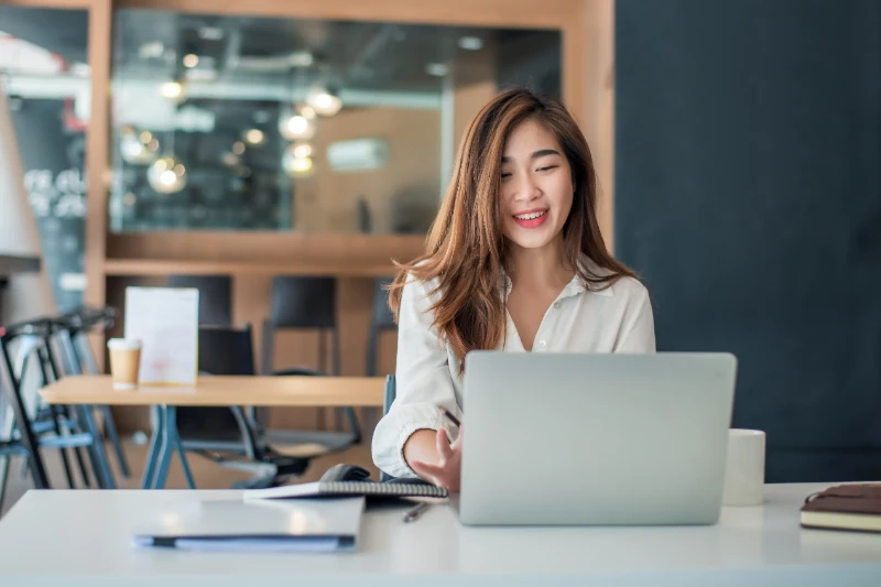 Charming-asian-businesswoman-sitting-working-on-laptop-in-office